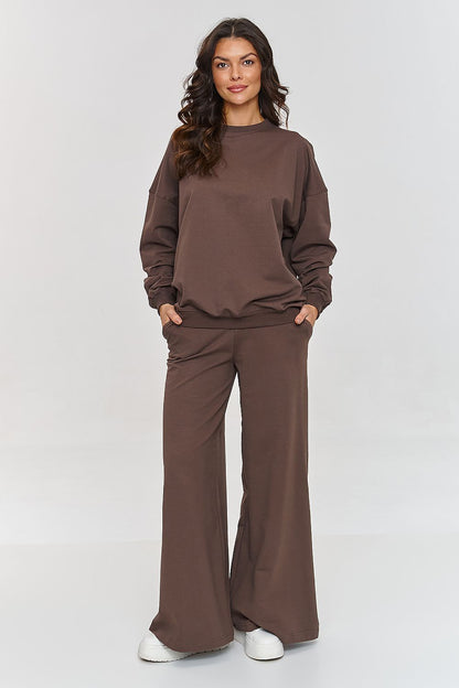 Chic Makadamia oversized tracksuit set featuring a soft sweatshirt and comfortable flared pants, ideal for modern women's fashion.