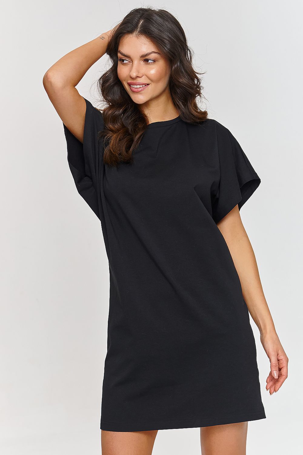Stylish model wearing the Makadamia Cotton Daydress, embodying chic summer fashion for casual outings.