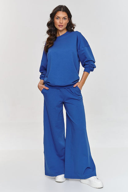 Chic Makadamia oversized tracksuit displaying a contemporary flared leg silhouette and a classic round neckline, designed for ultimate comfort.