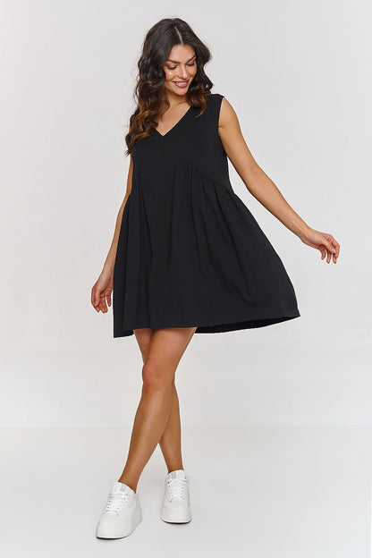 Stylish Makadamia trapeze dress displayed on a mannequin, showcasing its loose fit and breathable cotton material ideal for summer.