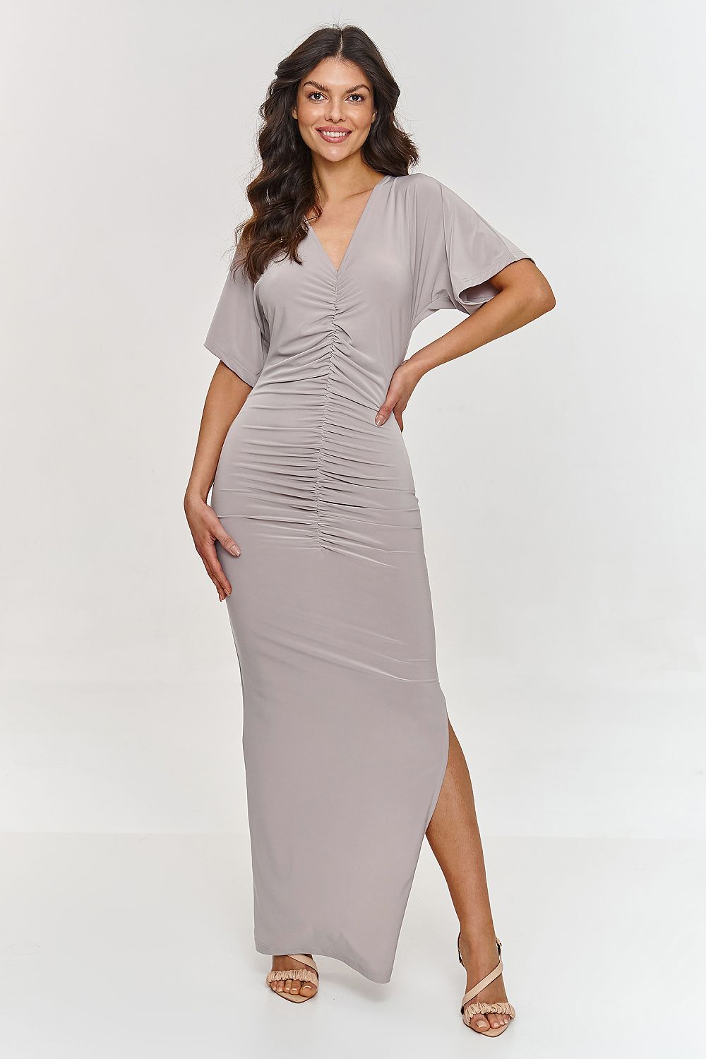 Elegant Makadamia maxi dress featuring a sophisticated V-neck and alluring side slit, perfect for special occasions. Available in sizes EU 36-42 and US 4-10.