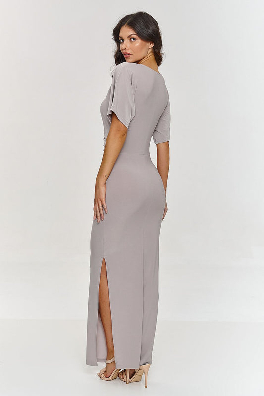 Elegant Makadamia maxi dress with V-neck and side slit, showcasing a slender silhouette perfect for formal occasions.