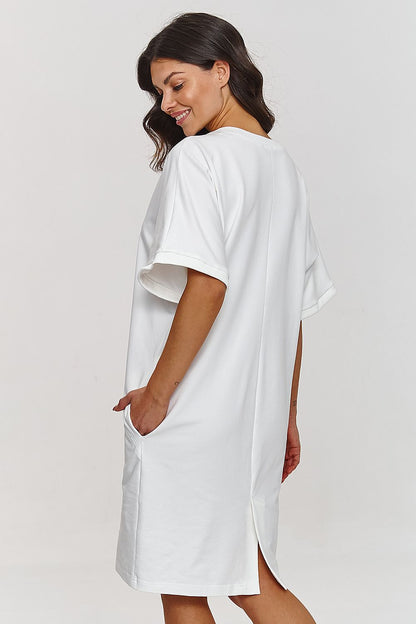 Model wearing the Elegant Short Sleeve Daydress by Makadamia, illustrating its versatility for various occasions with an elegant accessories pairing.