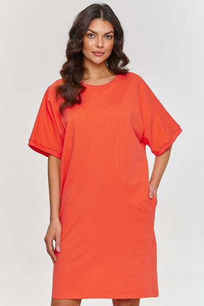 Back view of the Elegant Short Sleeve Daydress by Makadamia, demonstrating its relaxed fit and functional pockets.