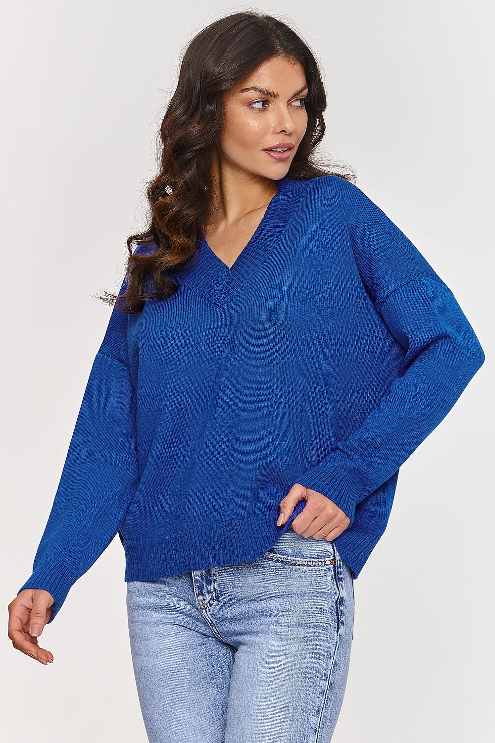 Model wearing Makadamia V-Neck Sweater, illustrating its timeless elegance and flattering loose cut.