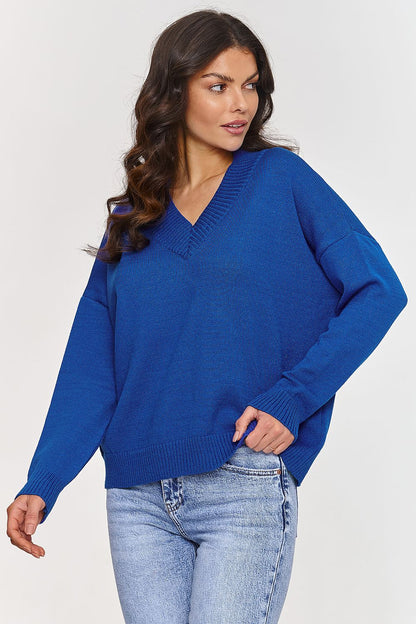 Model wearing Makadamia V-Neck Sweater, illustrating its timeless elegance and flattering loose cut.