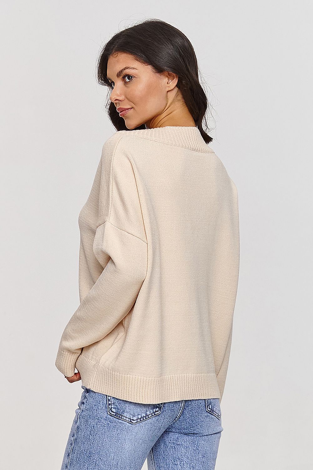 Profile view of the Makadamia V-Neck Sweater demonstrating the flattering V-neckline and modern design.