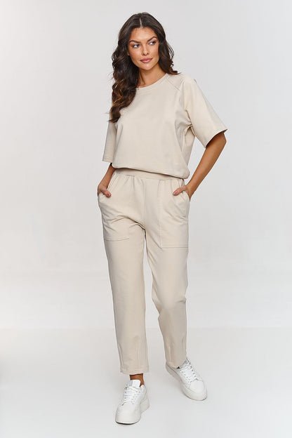 Makadamia Comfort Tracksuit Set laid out elegantly, highlighting classic pants and a loose blouse crafted from soft, breathable cotton.