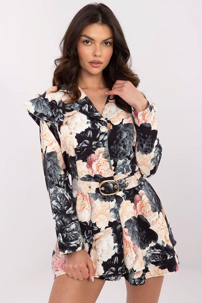 Elegant women's mini jumpsuit by Italy Moda featuring a floral print, ruffled shoulders, and long sleeves, perfect for classy outings and formal occasions.