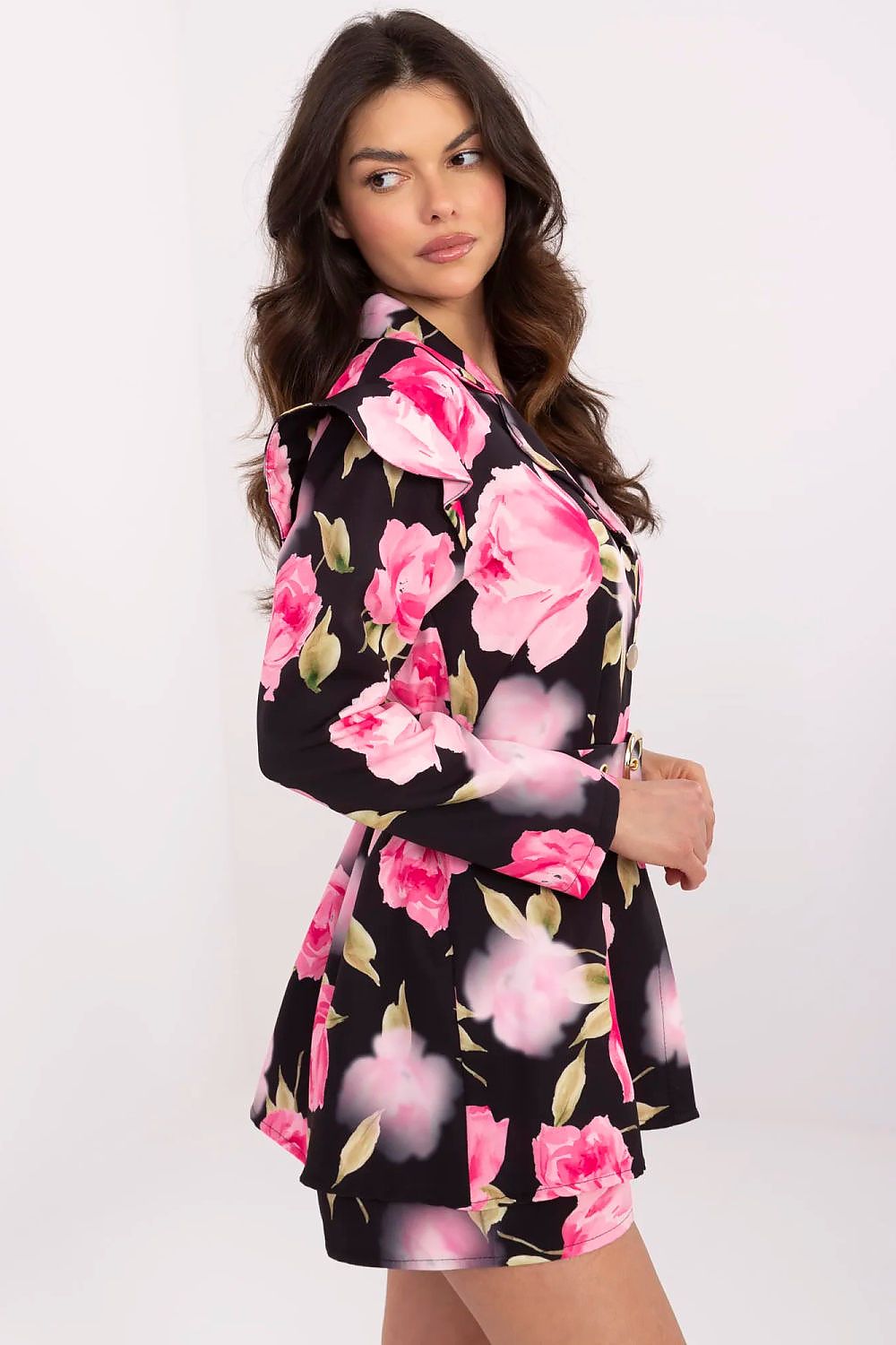 Elegant women's mini jumpsuit by Italy Moda featuring a floral print, ruffled shoulders, and long sleeves, designed for sophisticated occasions.