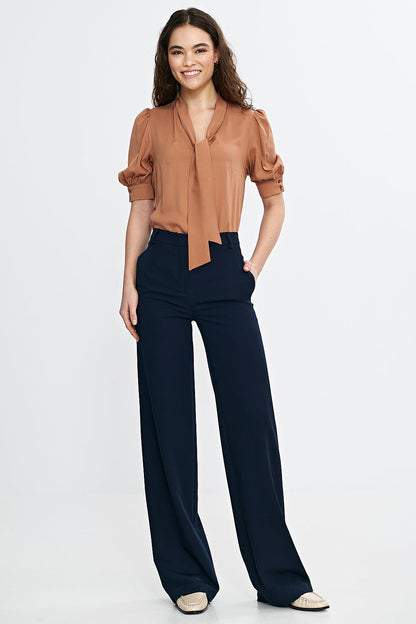 Nife's elegant blouse crafted from breathable viscose, highlighting feminine elbow-length puff sleeves and a sleek V-neckline for graceful styling.