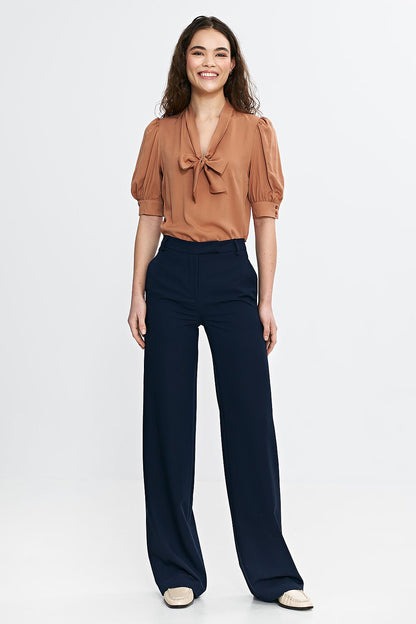 Close-up of the elegant bootcut trousers by Nife, featuring a chic high-waist design and functional side pockets for a sophisticated look.