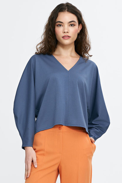 Detail of Nife oversized V-neck blouse demonstrating the plush texture and refined styling of the viscose blend material, designed for ultimate comfort and style.