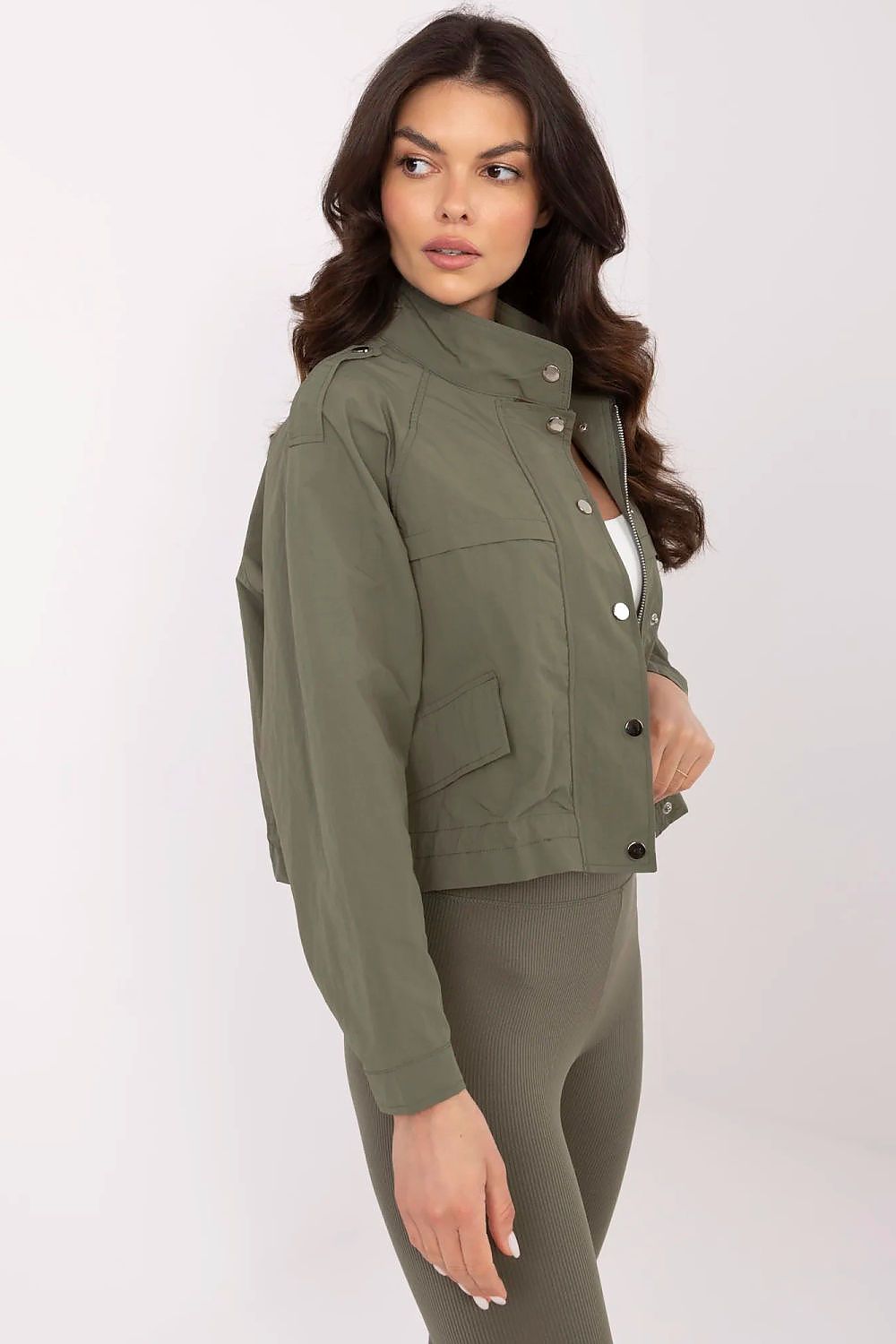 Model wearing NM luxury women's polyester windbreaker jacket, styled with jeans for a casual yet chic spring look.