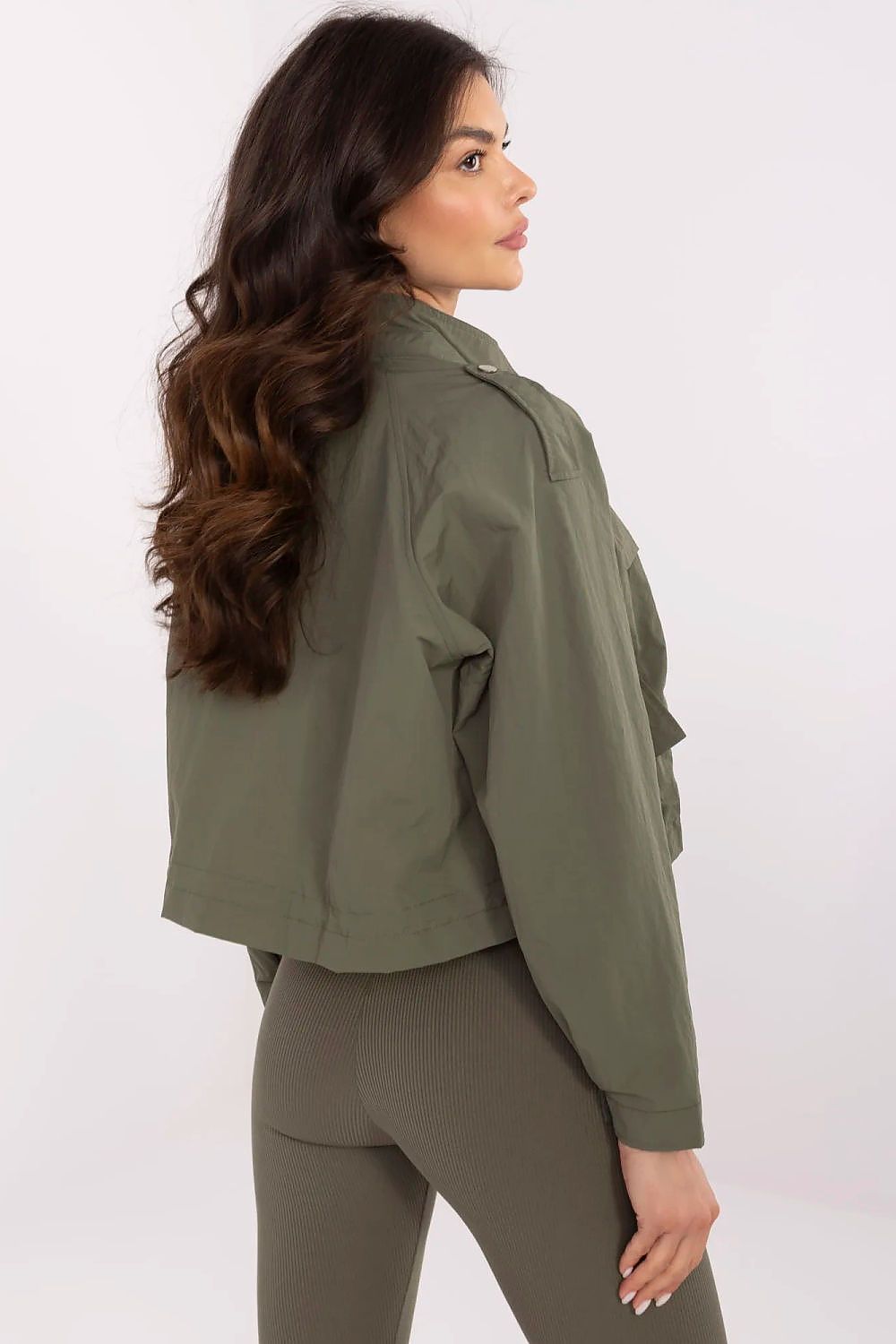 Back view of NM women's polyester windbreaker jacket, highlighting the short cut and practical snap button placket for added warmth.