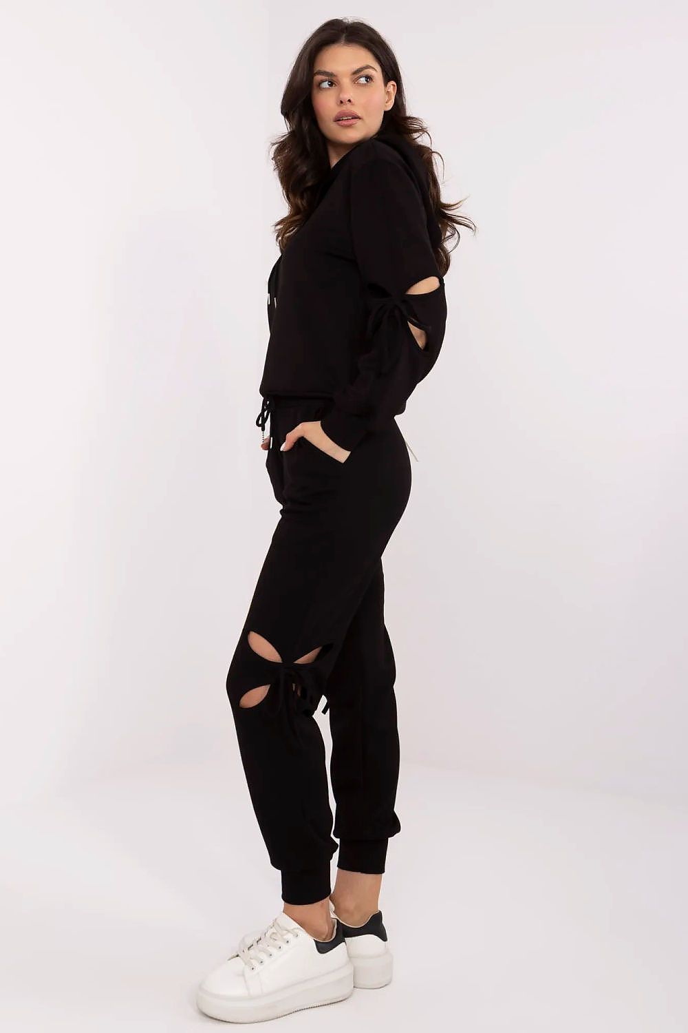 Luxury women's casual tracksuit set by NM with decorative ties and high-waisted pants in soft, comfortable fabric.