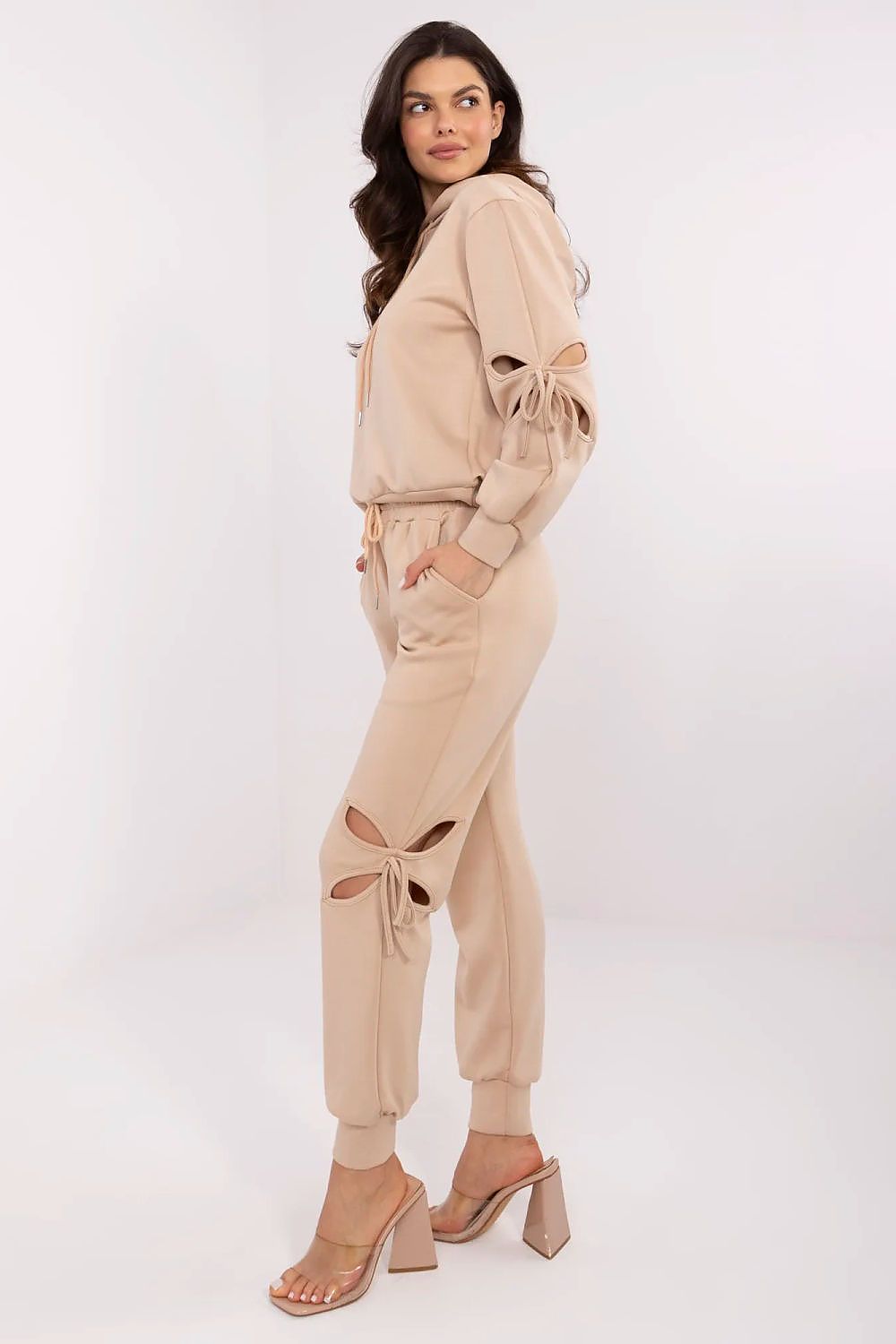 Soft and comfortable women's tracksuit by NM, showcasing unique slits with decorative ties for a fashionable touch.