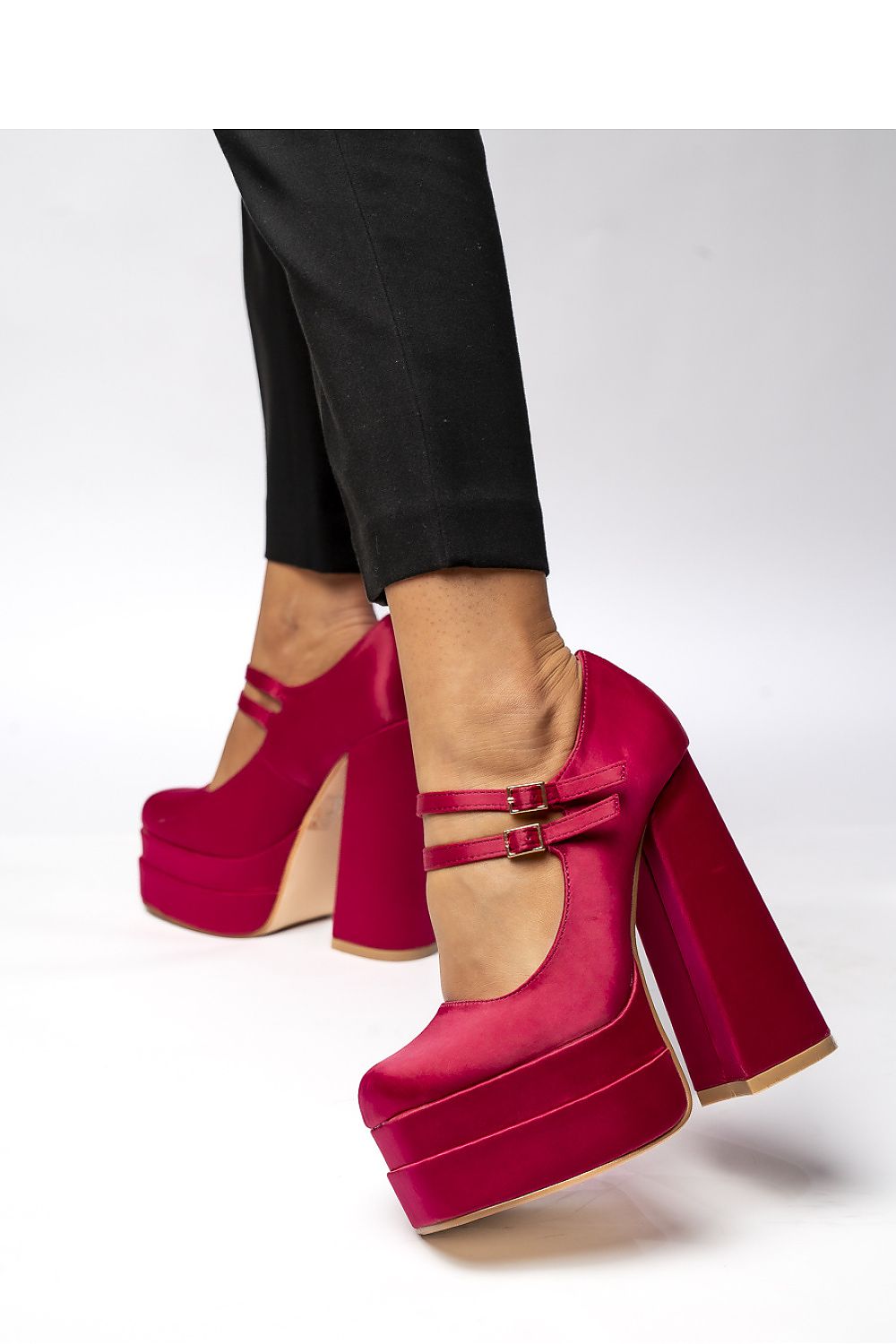 Close-up of Inello fuchsia satin platform pumps highlighting the double buckle strap and luxurious shine, perfect for evening wear.