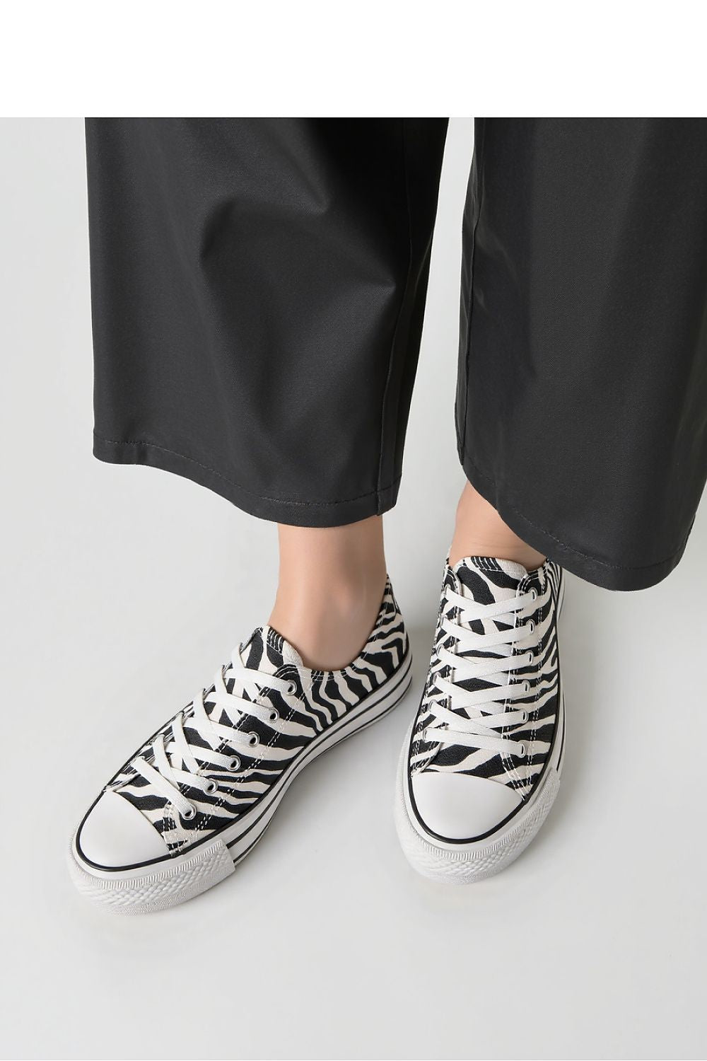 Inello Savana Zebra Sneakers with rubber sole, highlighting chic streetwear appeal and bold fashion design.