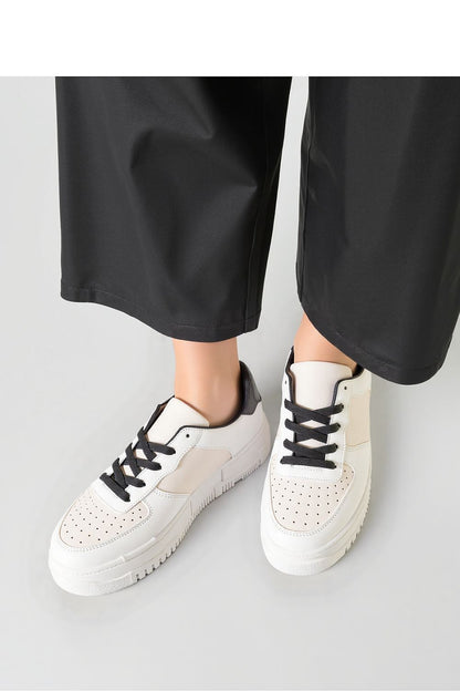 VEXANA beige perforated sneakers elegantly styled against a chic urban backdrop, complemented with thick sturdy soles for comfort, by Inello.