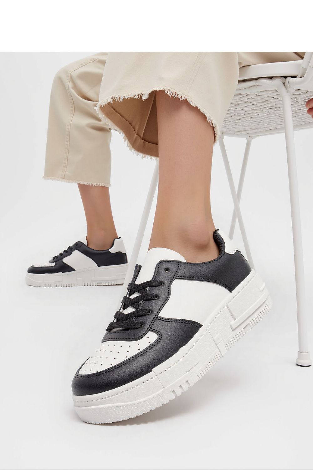 Side angle of Inello Vexana Black Eco-Leather Sneakers showcasing the versatile black and white colour scheme, ideal for various wardrobe styles.