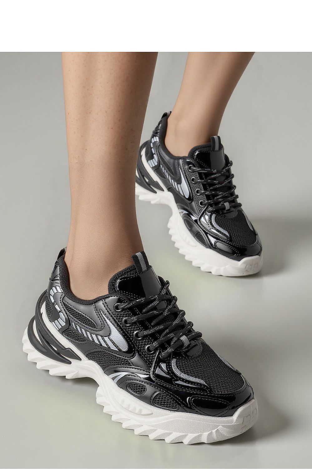 JAYDEN Black Sport Sneakers by Inello featuring a futuristic design with breathable mesh and synthetic leather, showcasing a shiny black upper and a contrasting massive sole for ultimate comfort and style.