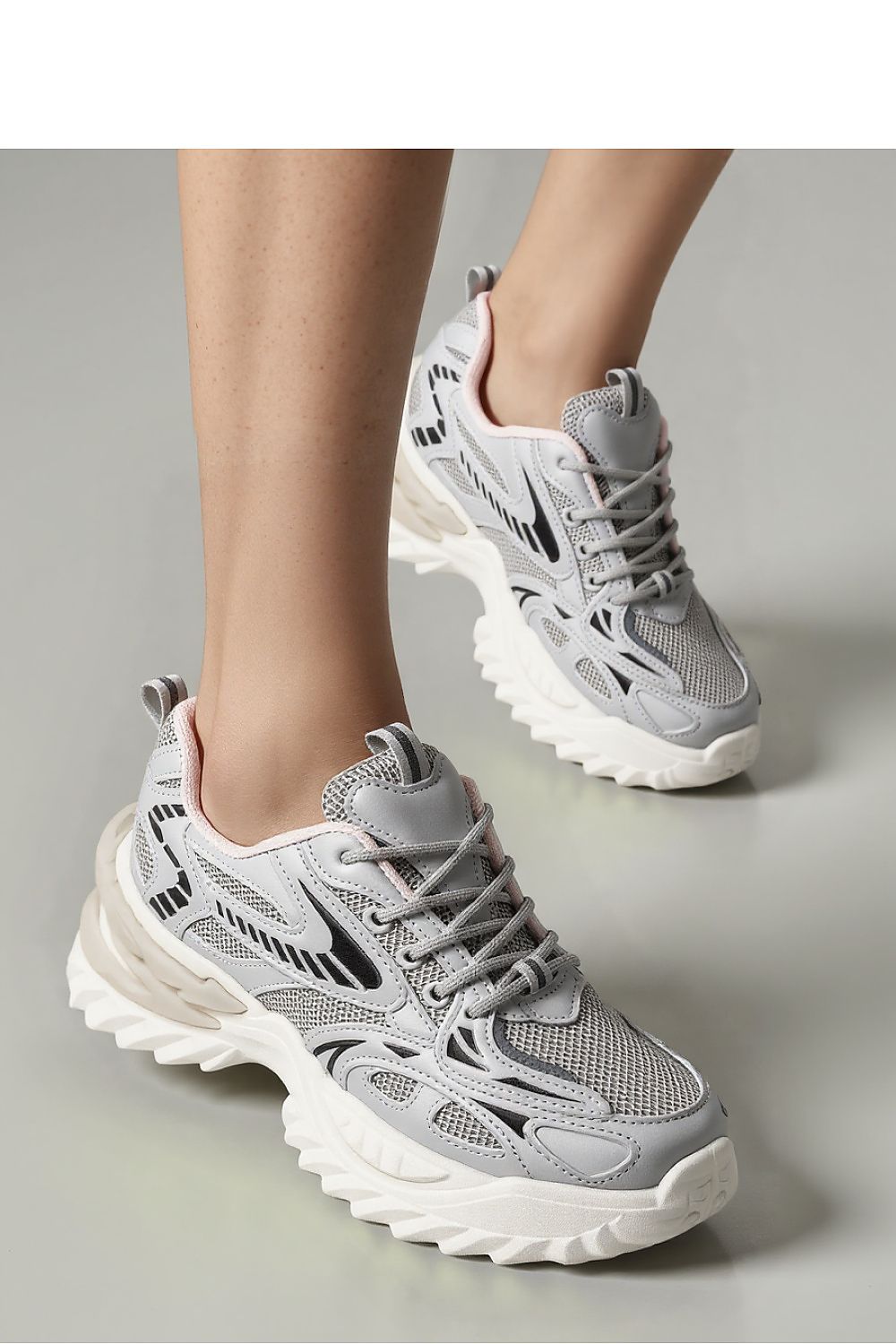 Detail shot of the Inello JAYDEN Silver Sport Shoes, highlighting the sleek synthetic leather upper and dynamic sole, epitomising luxury and comfort.