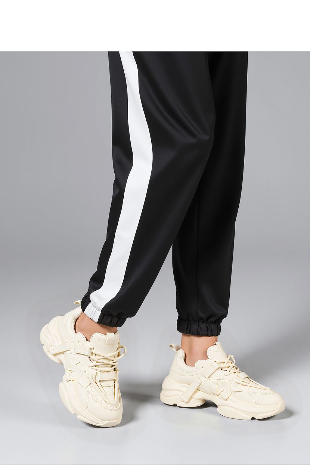 Inello Titan Beige Sneakers paired with trendy streetwear, demonstrating the perfect blend of comfort and high-fashion elegance on a massive platform.