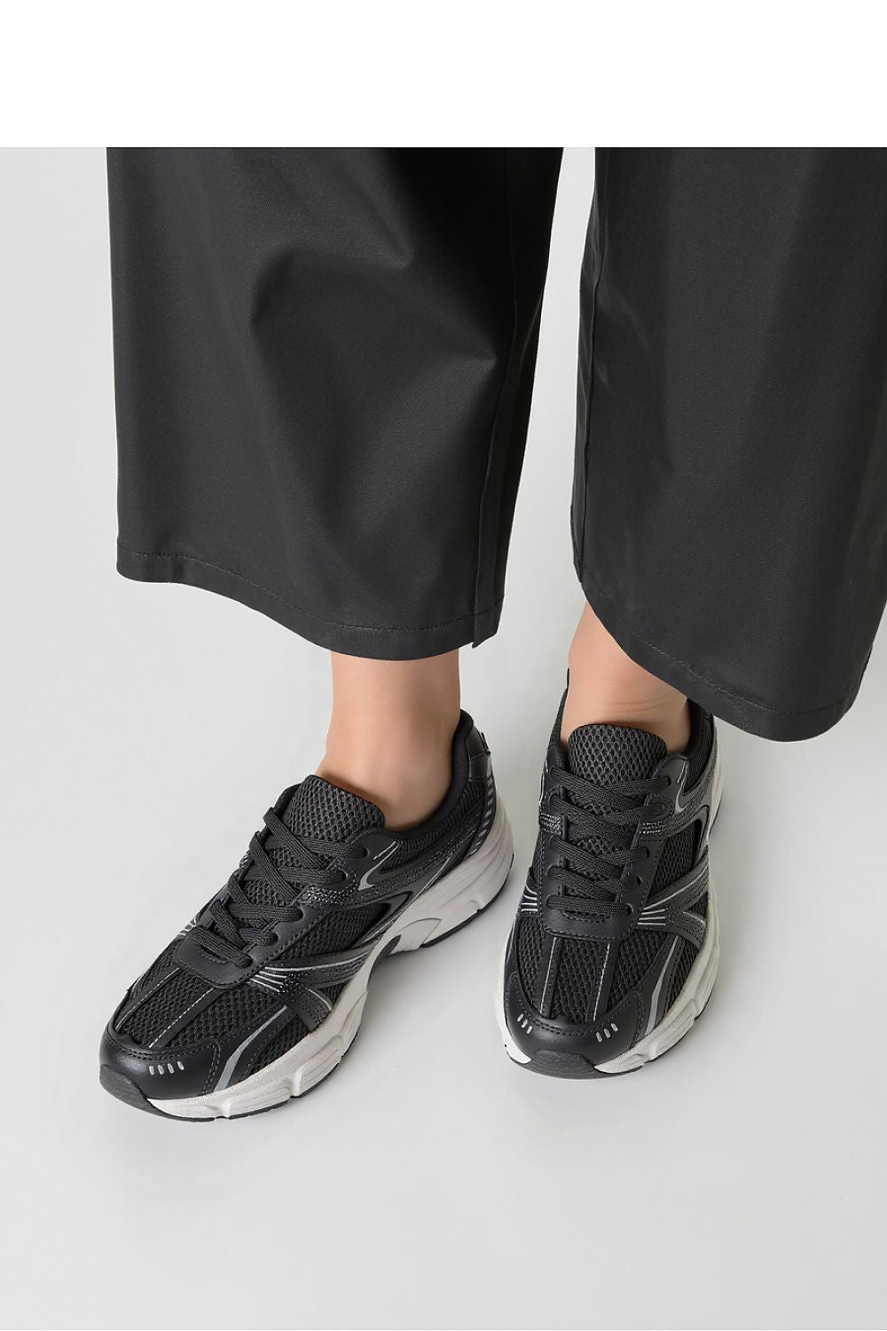 Close-up of Inello Dynamic Black Sports Sneakers featuring lightweight textile and faux leather for a stylish, breathable wear.