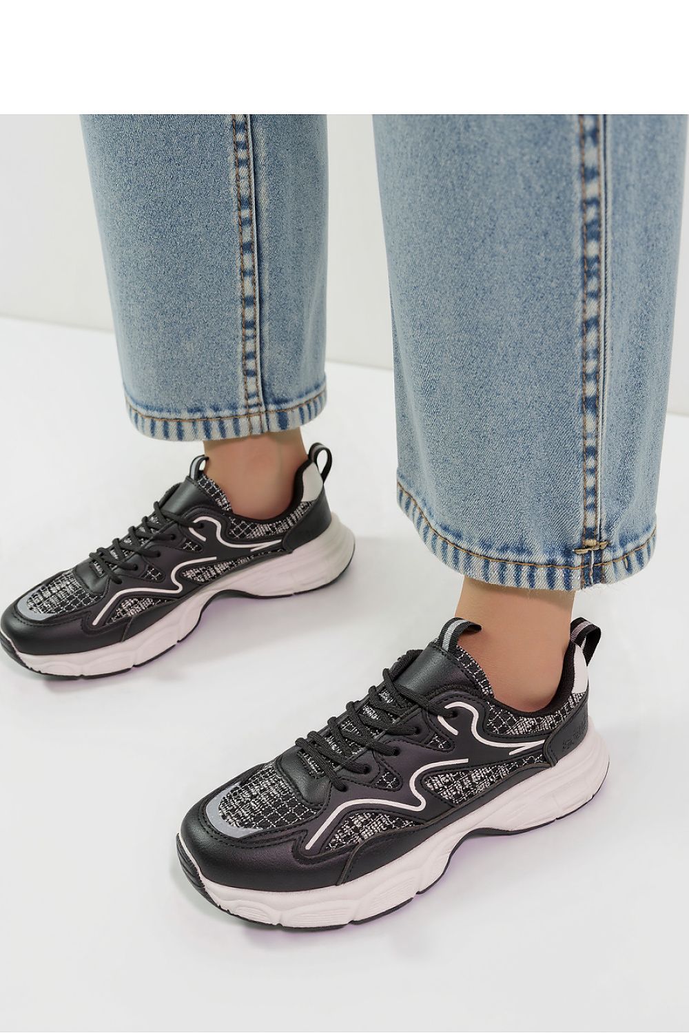 Close-up view of Stellar Black Urban Sport Sneakers by Inello, emphasising the raised sole and eco-friendly materials, perfect for urban sporty chic.