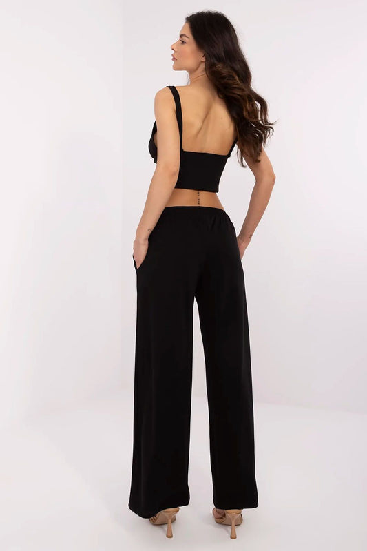 Back view of luxury cotton-blend tracksuit trousers for men and women by Relevance, highlighting the smooth waistline and flattering fit, elegantly worn by a model.