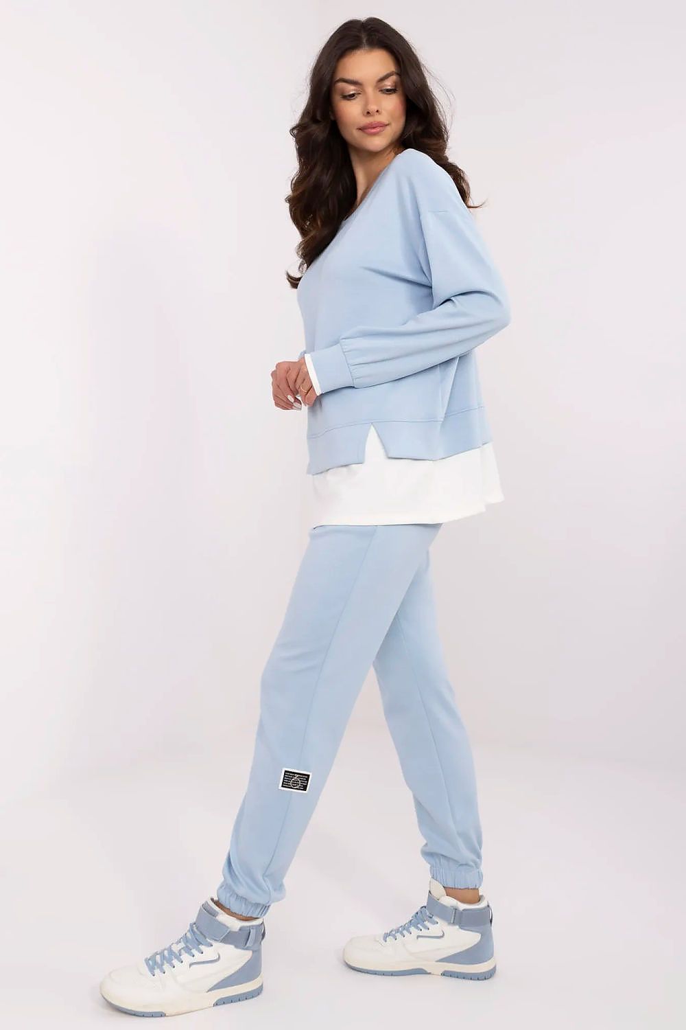 Luxury women's casual tracksuit set showcasing a light blue long-sleeve sweatshirt and high-waisted trousers, featuring a modern design by Relevance, perfect for everyday wear or relaxed outings.
