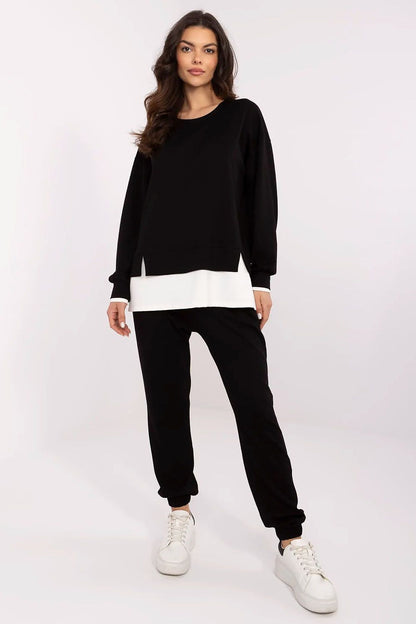 Chic women's casual tracksuit set in black, designed by Relevance, featuring a stylish long-sleeve sweatshirt and relaxed high-waisted trousers, ideal for luxurious everyday wear.