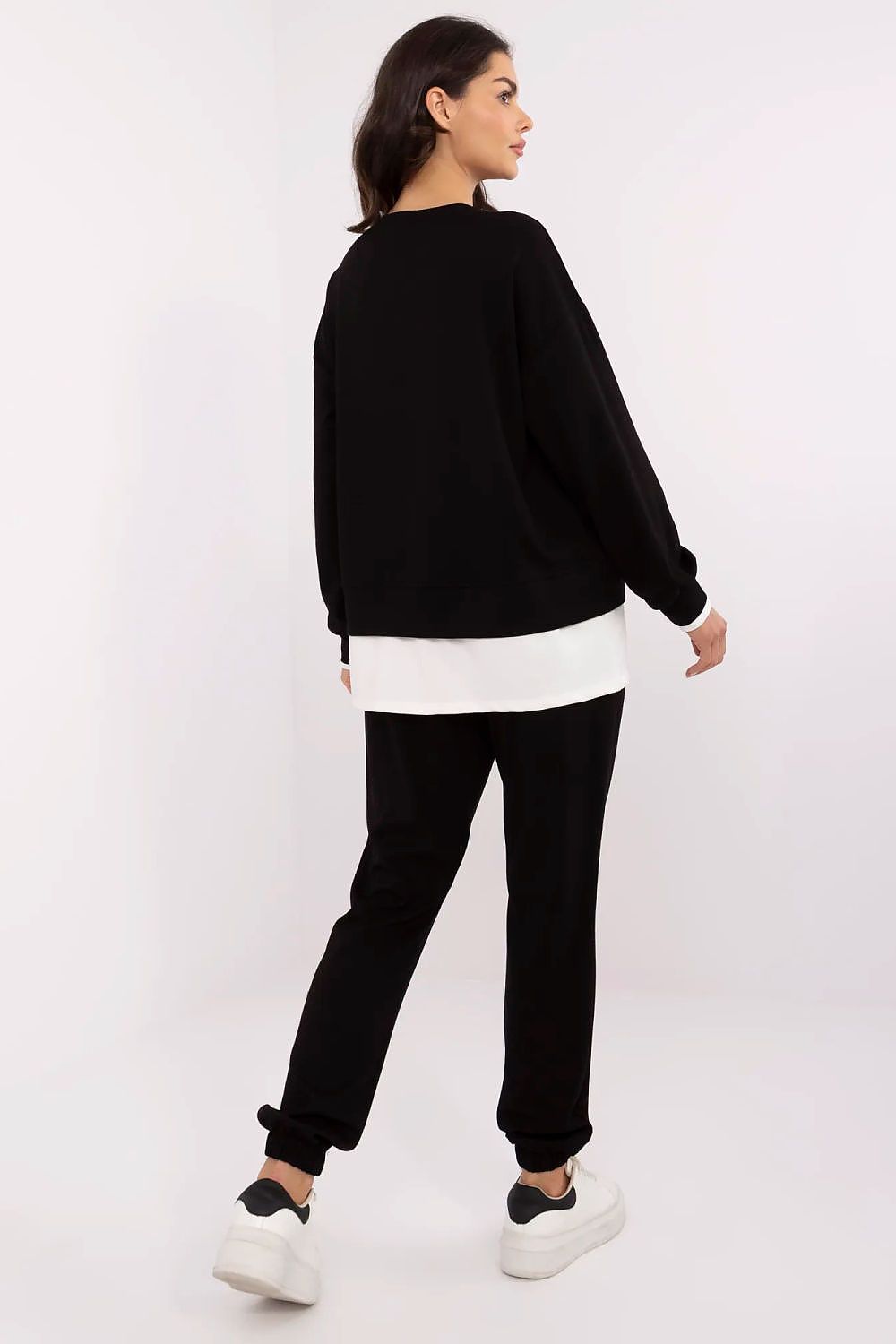 Stylish luxury women's casual tracksuit set from Relevance, featuring a black long-sleeve sweatshirt with contrasting insert and high-waisted pants, perfect for lounging or casual outings.