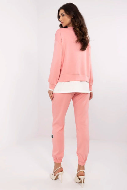 Chic luxury women's casual tracksuit set from Relevance, with a pink sweatshirt and high-waisted trousers, designed for both relaxation and stylish outings.