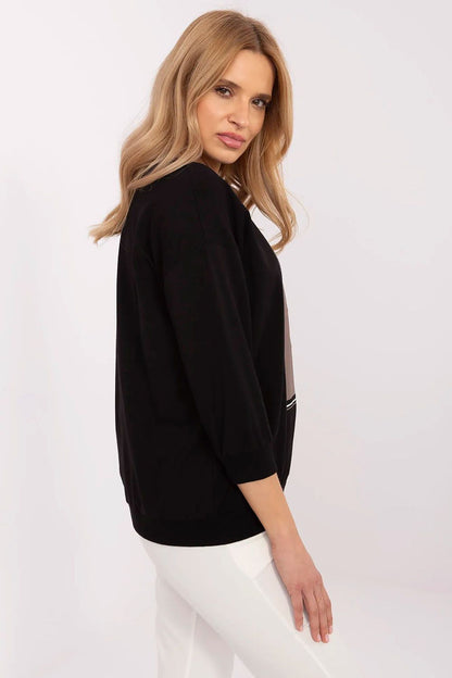 Elegant casual women's blouse with 3/4 sleeves in black, showcasing a sophisticated silhouette, available at Relevance.