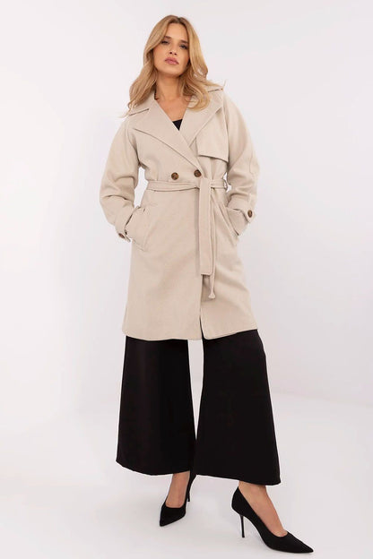 Chic women's knee-length double-breasted coat in beige by Och Bella, highlighting a stylish wrap and pocket design.