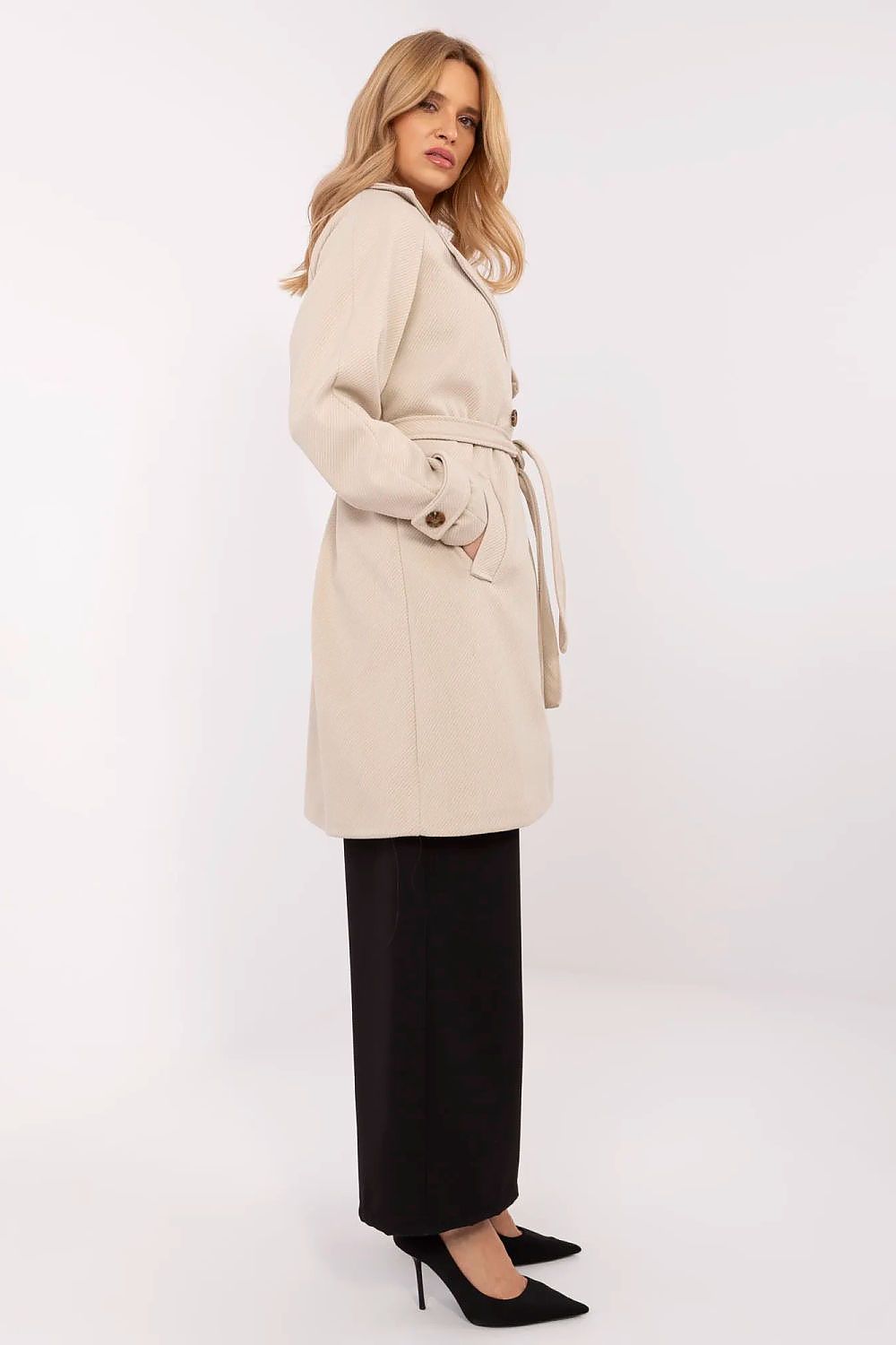 Side view of a luxurious women's knee-length coat in beige by Och Bella, featuring a wrap belt and sophisticated silhouette.