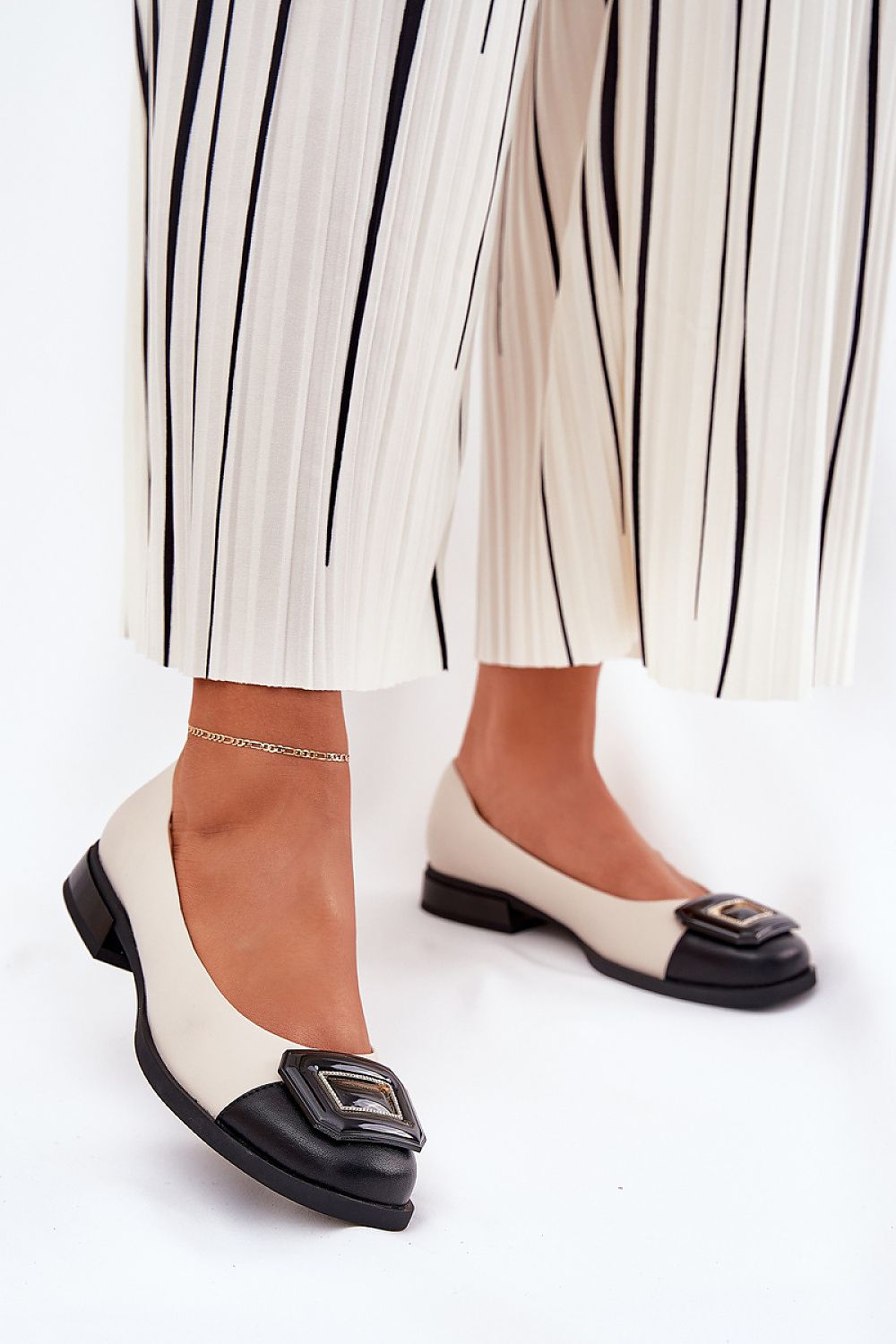 Chic women's ballet flats made from natural leather with a unique decorative element, styled with trendy trousers, by Step in Style.