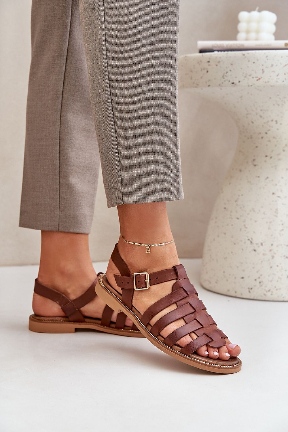Chic brown natural leather sandals by Step in Style, showcasing a comfortable woven design and adjustable strap, perfectly styled on a model's foot.