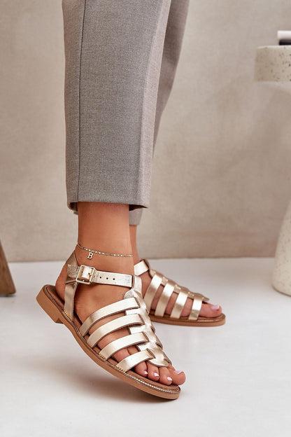Luxury gold natural leather sandals from Step in Style, featuring a sophisticated woven style and adjustable strap, elegantly showcased from a model's perspective.