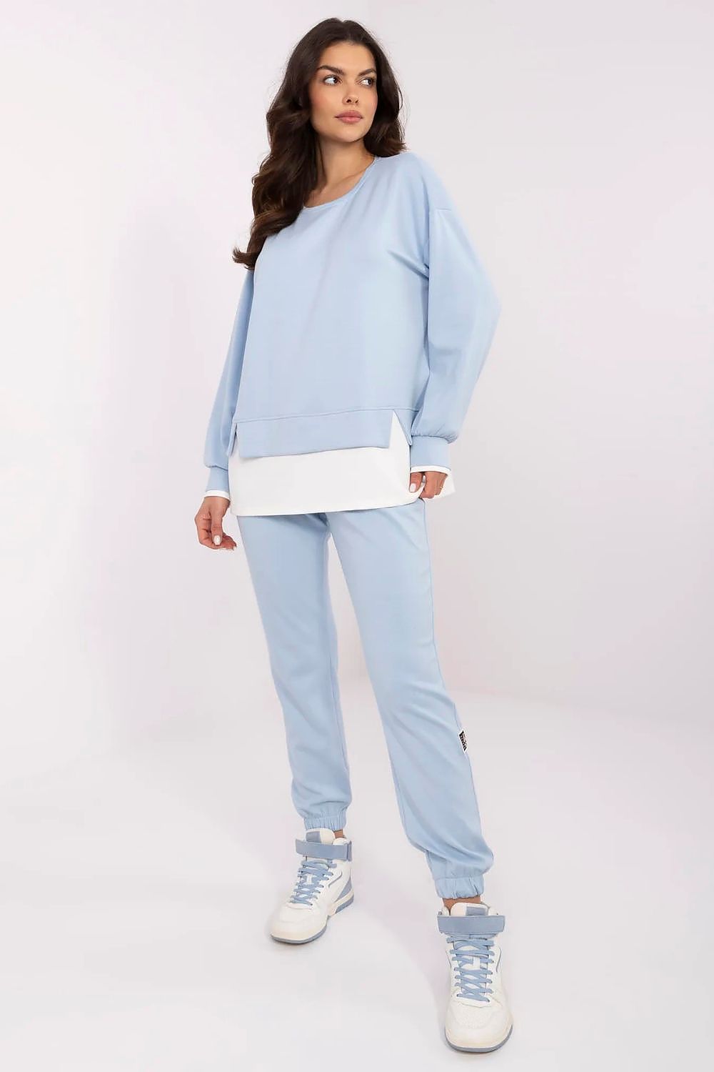 Fashionable women's casual tracksuit set in light blue, highlighting the long-sleeve sweatshirt and tapered high-waisted pants designed by Relevance, perfect for sophisticated leisure attire.