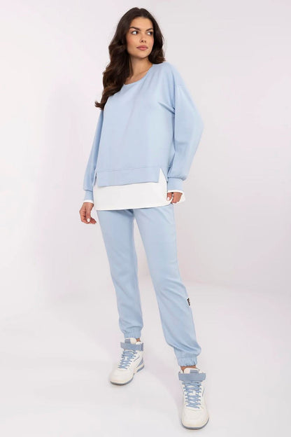 Fashionable women's casual tracksuit set in light blue, highlighting the long-sleeve sweatshirt and tapered high-waisted pants designed by Relevance, perfect for sophisticated leisure attire.