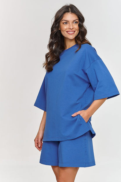 Luxury men's tracksuit set for women in blue from Makadamia, showcasing a relaxed fit oversized t-shirt with short sleeves and matching shorts with side pockets.