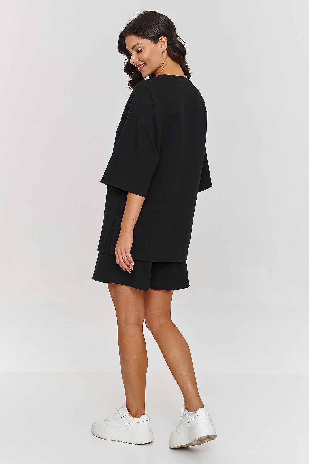 Sophisticated model wearing a black tracksuit set from Makadamia, highlighting the relaxed fit and stylish design for both leisure and activity.