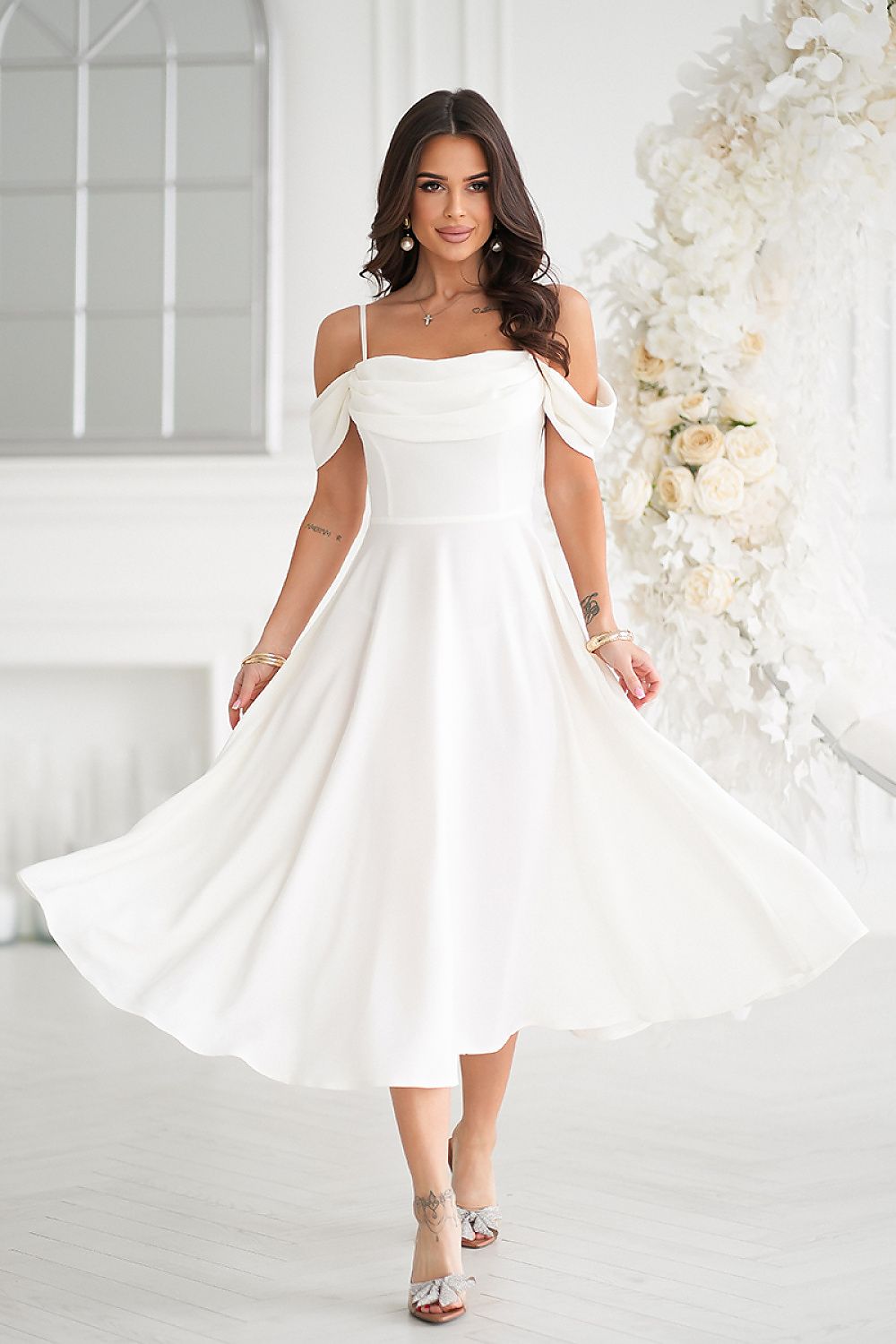 Elegant ecru midi dress by Bicotone, featuring a draped top and dropped sleeves, showcased with a flowing silhouette against a light, airy backdrop.