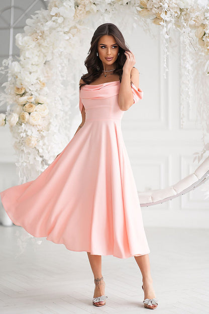Graceful pink midi dress in motion, featuring a flattering silhouette and draped neckline, exuding luxury from Bicotone.