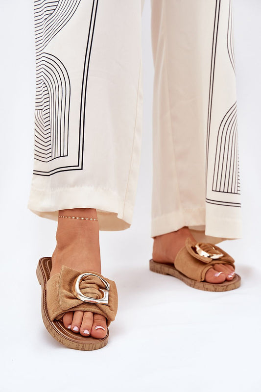 Stylish eco suede women's flip-flops featuring elegant gold detail, worn with chic wide-legged trousers, from Step in Style.