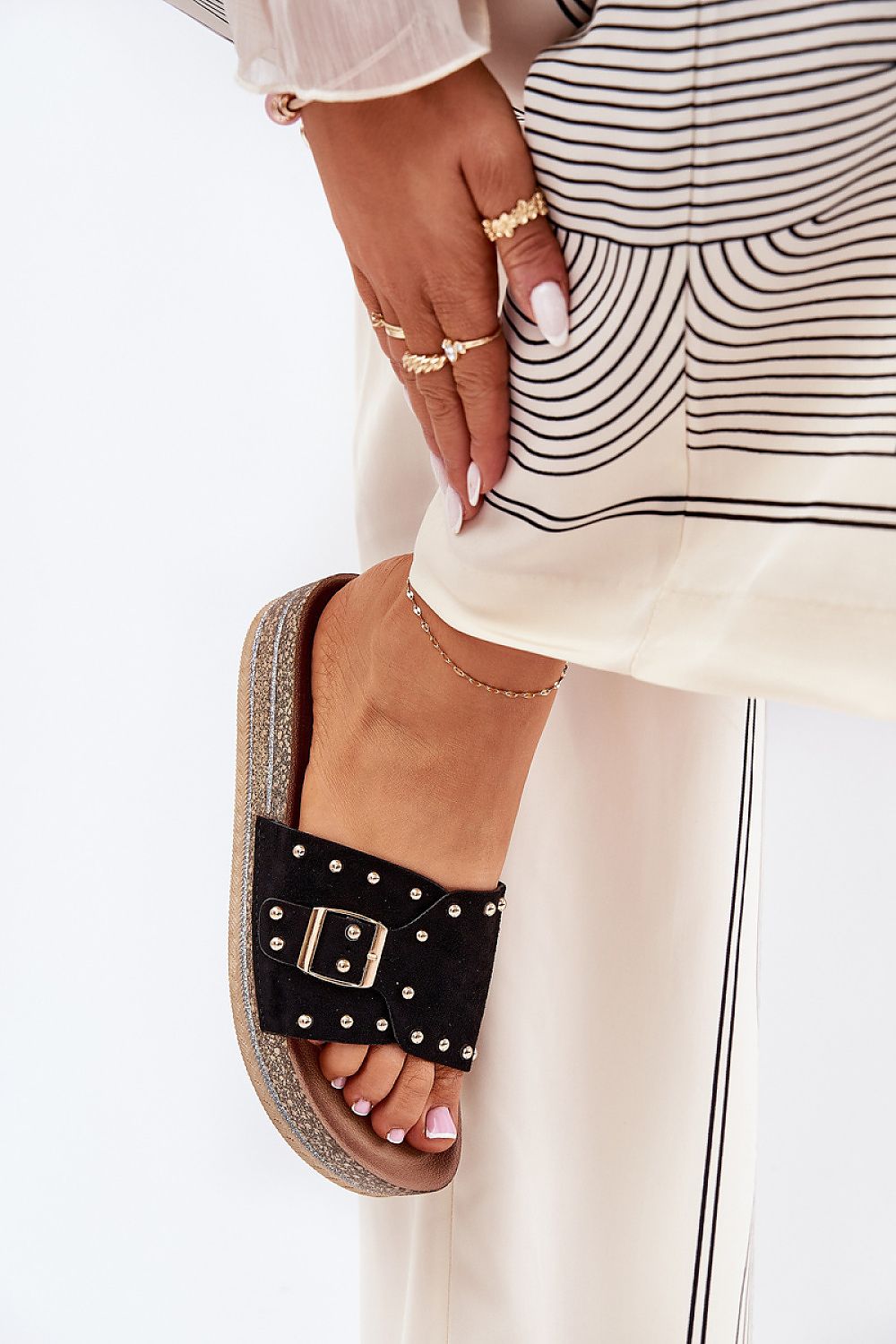 Sophisticated women's black sandals featuring a bold buckle and stud detailing, comfortably positioned on a platform, ideal for summer days, by Step in Style.