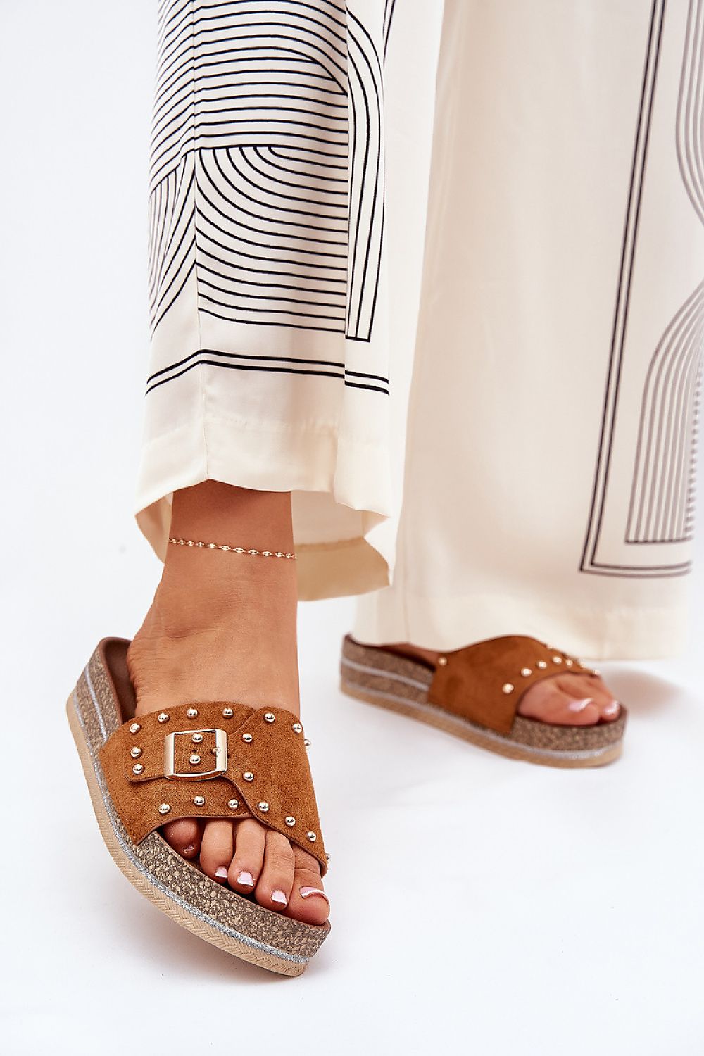 Chic brown eco suede platform sandals with a buckle and studs, beautifully styled with elegant attire, perfect for adding luxury to summer looks, by Step in Style.
